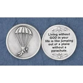 Two round silver-toned medallion coins shown side by side on a textured blue background. The left coin features an embossed parachute design, and the right coin is engraved with the quote: 'Living without GOD in your life is like jumping out of a plane without a parachute.
