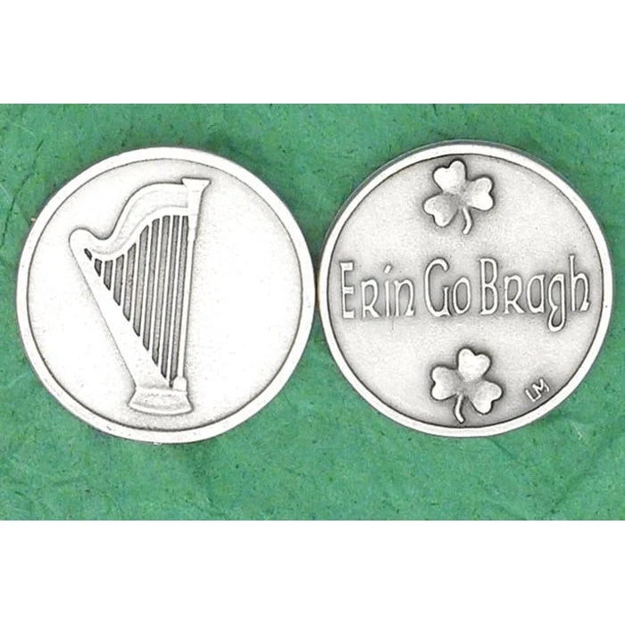 Two round silver-toned coin-like medallions shown side by side on a textured green background. The left medallion features a harp, and the right medallion reads 'Erin Go Bragh' with shamrock motifs.
